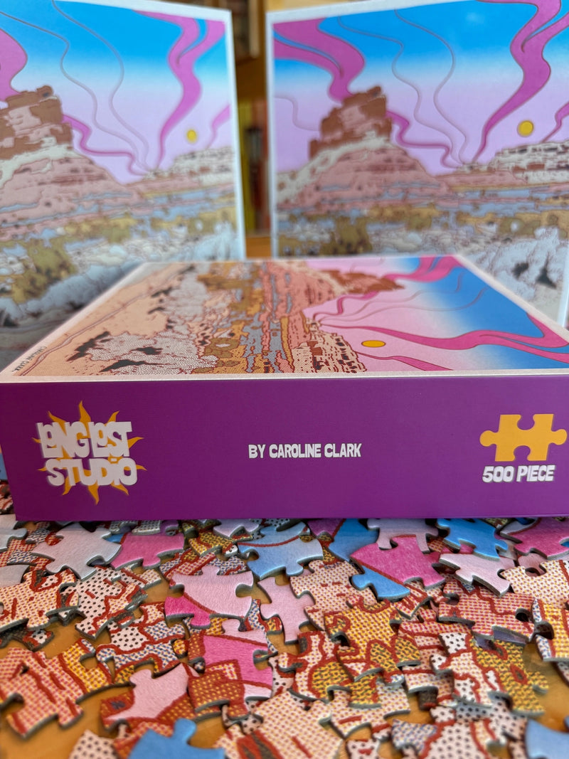 Jigsaw puzzle box with colorful artwork and 'Long Lost Studio' branding.