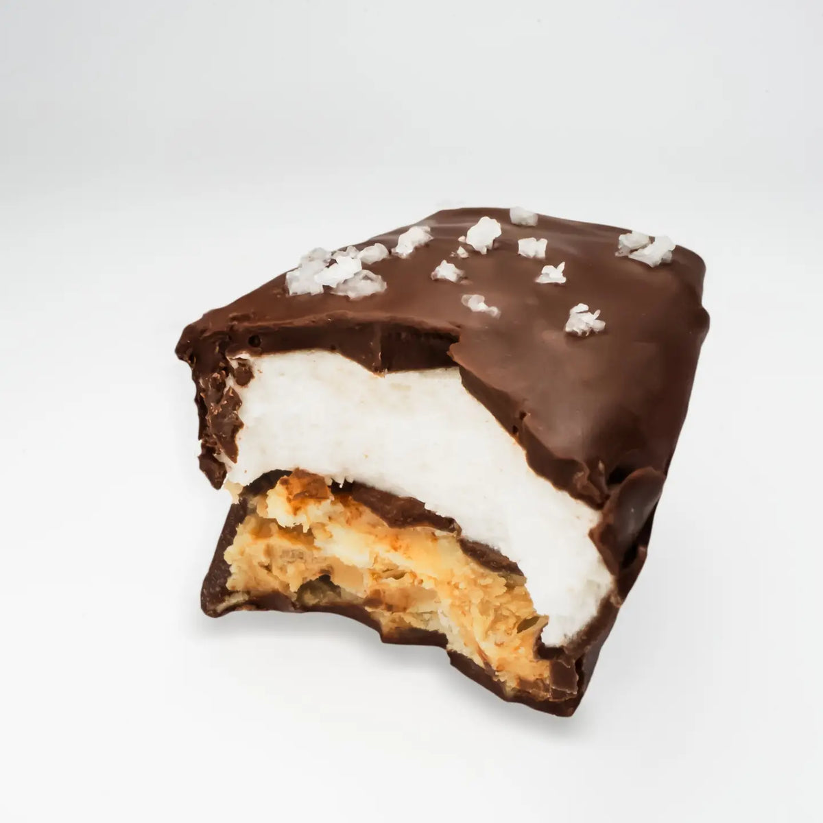 Chocolate-dipped treat with a white filling on a light gray background