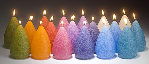 Barrick Design Candles lit and in and array of 18 colors 4.75" height and pear shaped 