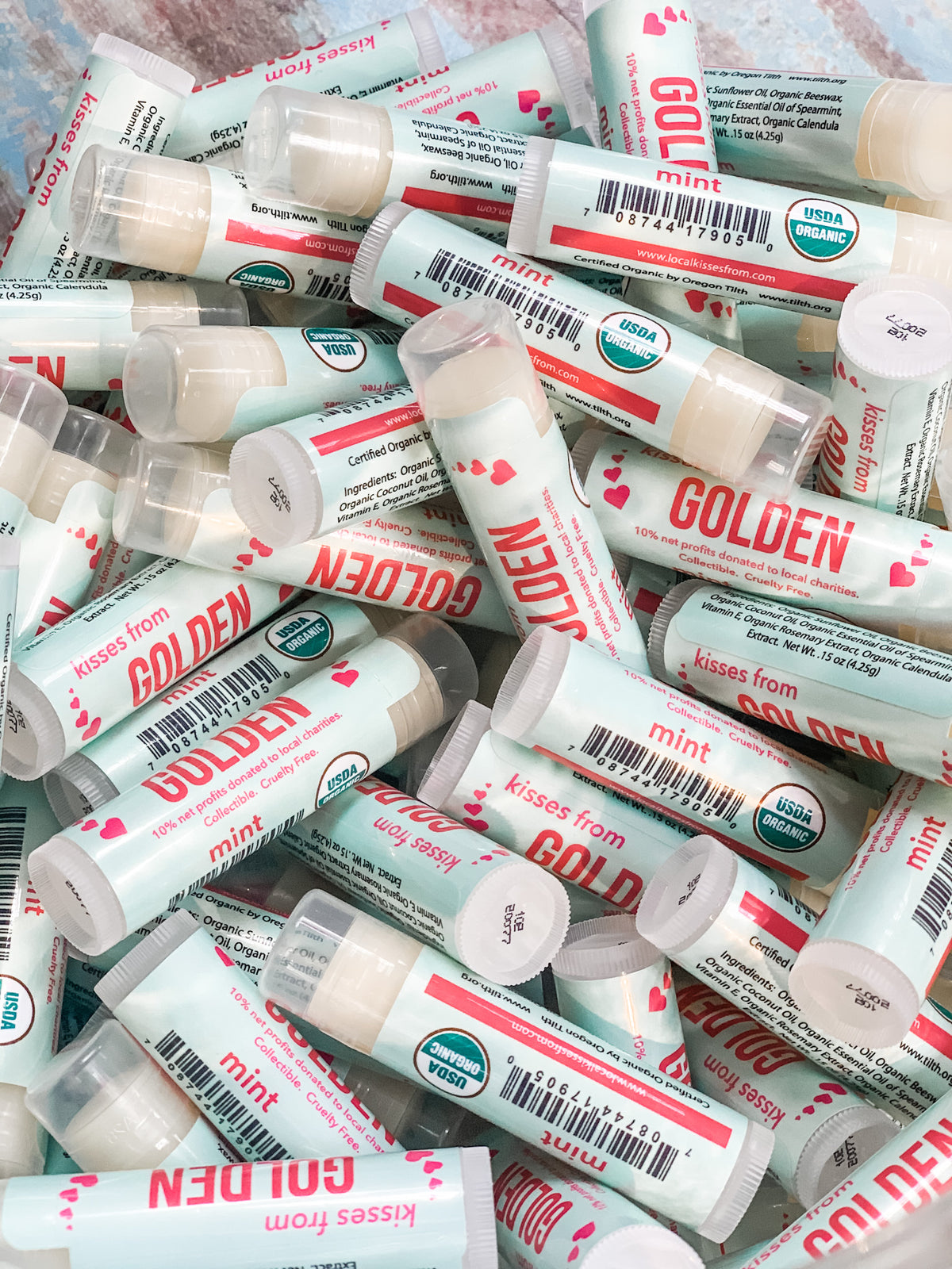 Jar full of mint colored and mint flavored "kisses from Golden" chapstick tubes