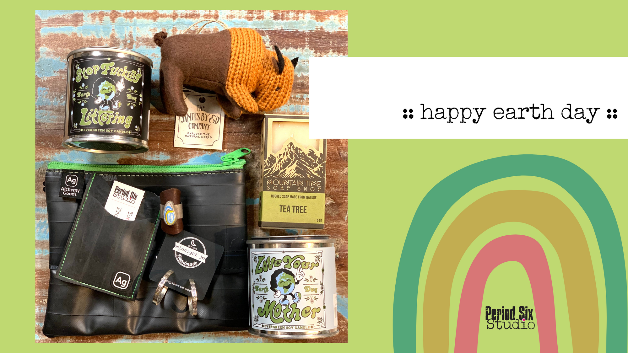 Earth Day Flay Lay of Environmentally Conscious Items for sale at Period Six including soaps, candles, jewelry, inner tube pouches and a knit buffalo ornament