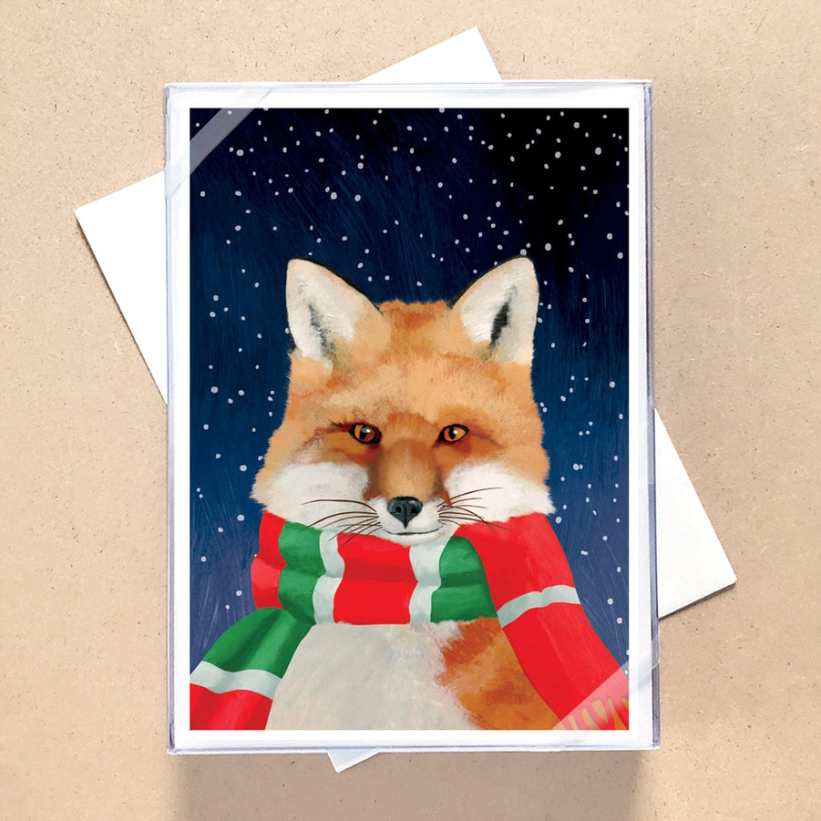 Card with a fox wearing a red and green scarf on a snowy night background