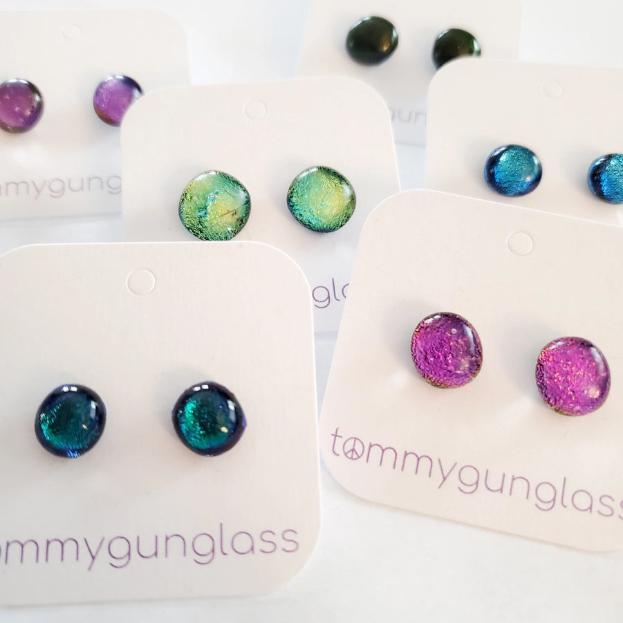 Colorful dichorn glass earrings on cards with 'tommygunglass' branding.