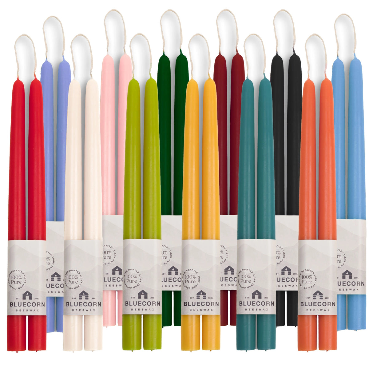A rainbow of colorful beeswax taper candles in various hues with visible Bluecorn branding.