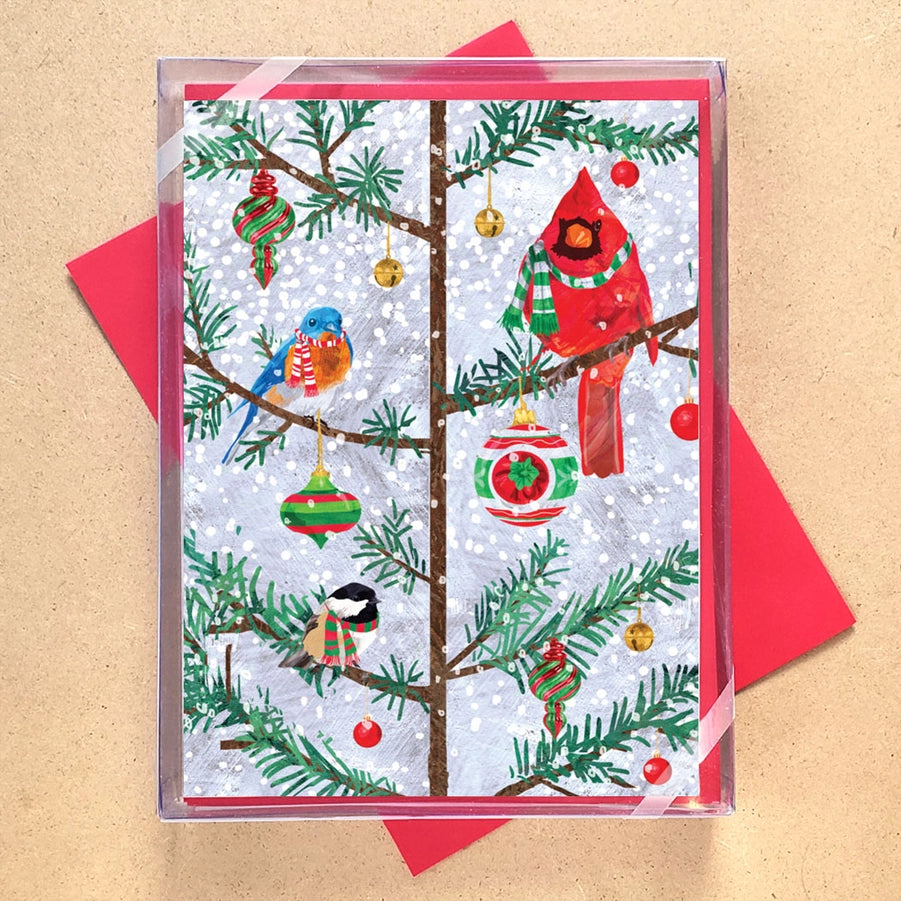Christmas-themed card with birds and ornaments on a tree, featuring a red envelope.
