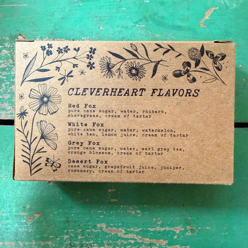 Cardboard box with floral designs and text on a green surface