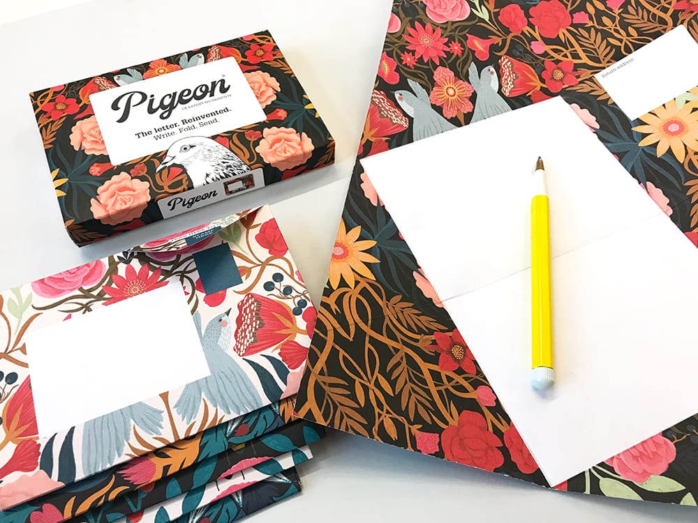 Floral-patterned notebooks and stationery items on a white surface