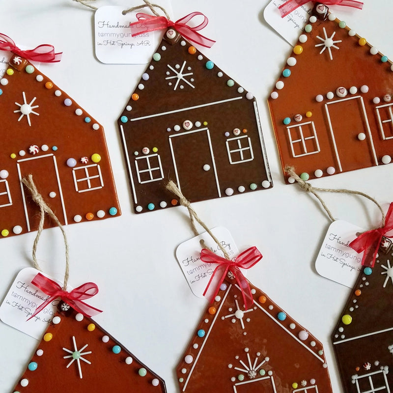 Decorative gingerbread house fused glass ornaments with colorful details on a white background.