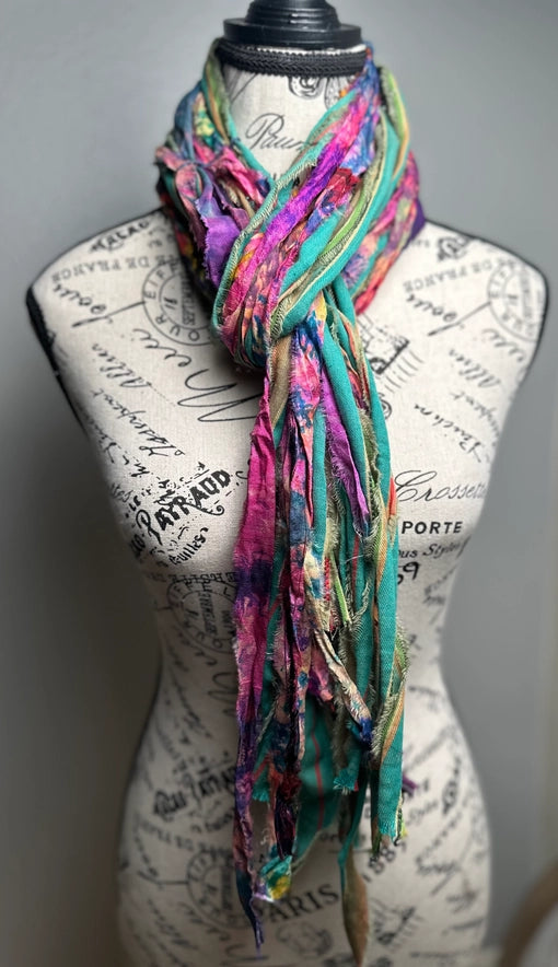 Colorful scarf on a mannequin with a script patterned background