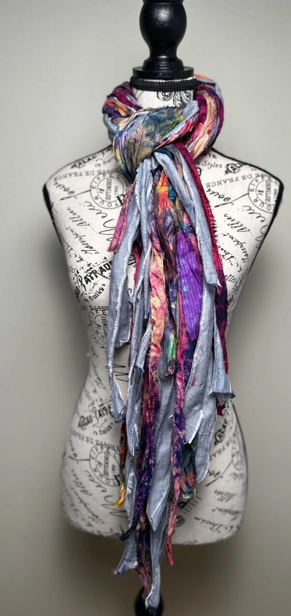 Colorful scarf draped over a mannequin bust with a vintage-style map background