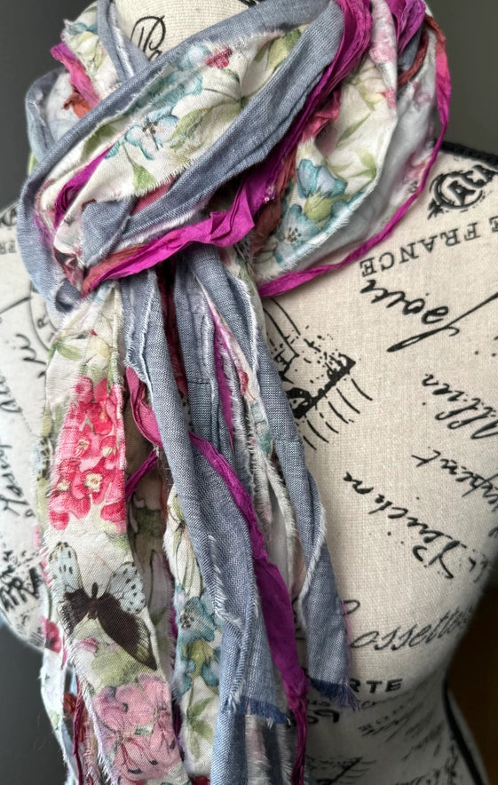 Colorful scarf on a mannequin head with script background