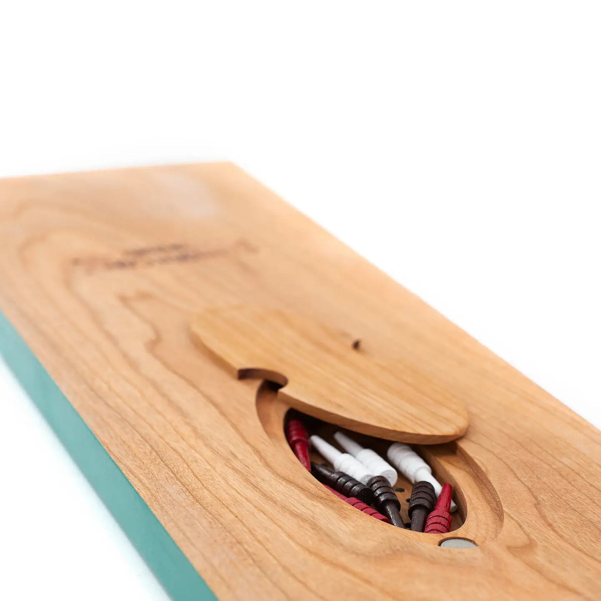 Wooden cribbage board with magnetic storage feature on a white background
