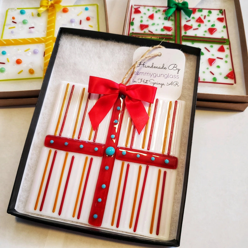 Decorative gift box with a red bow and colorful stripes, featuring 'Handmade By Tommygunglass'.
