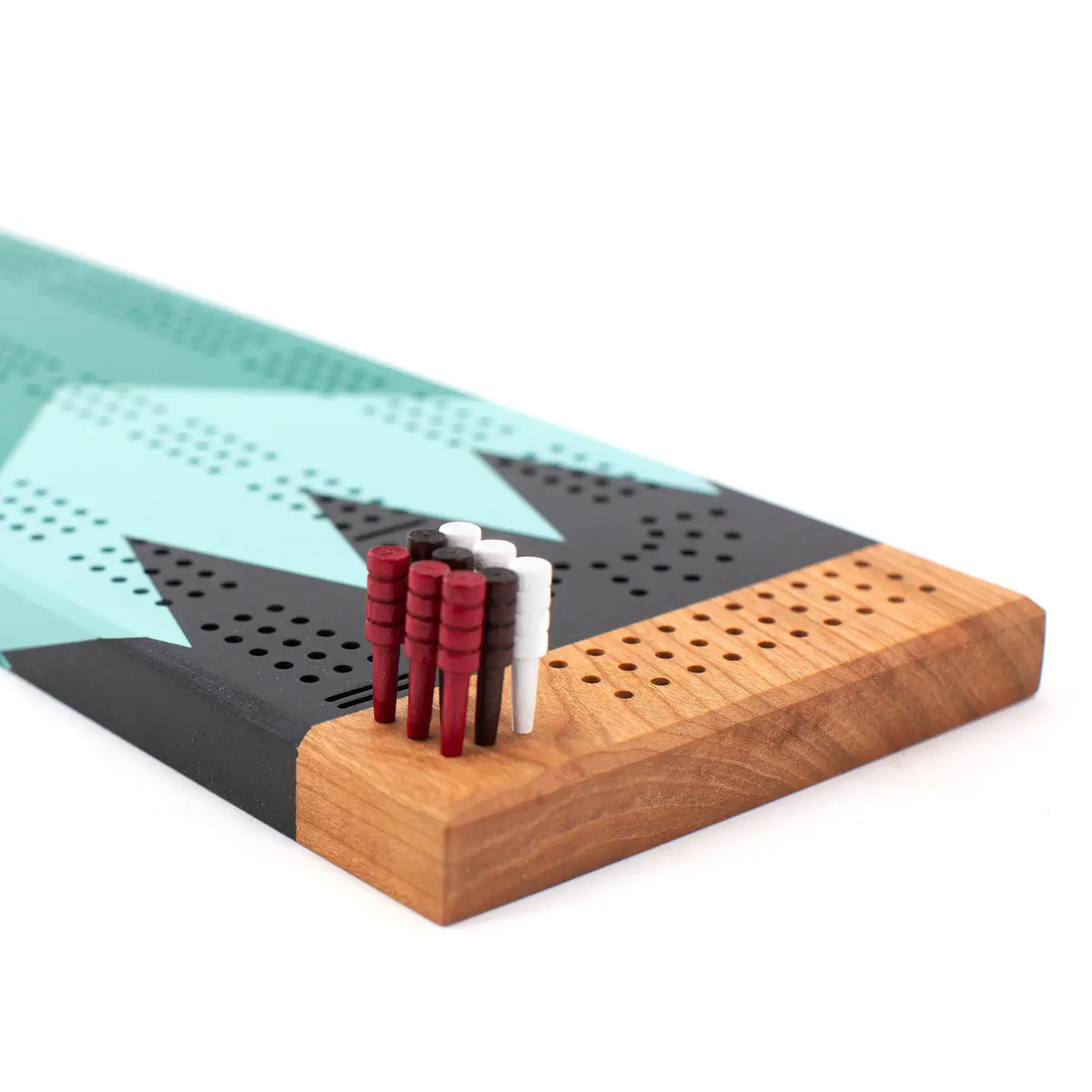 Wooden cribbage board with pegs on a white background