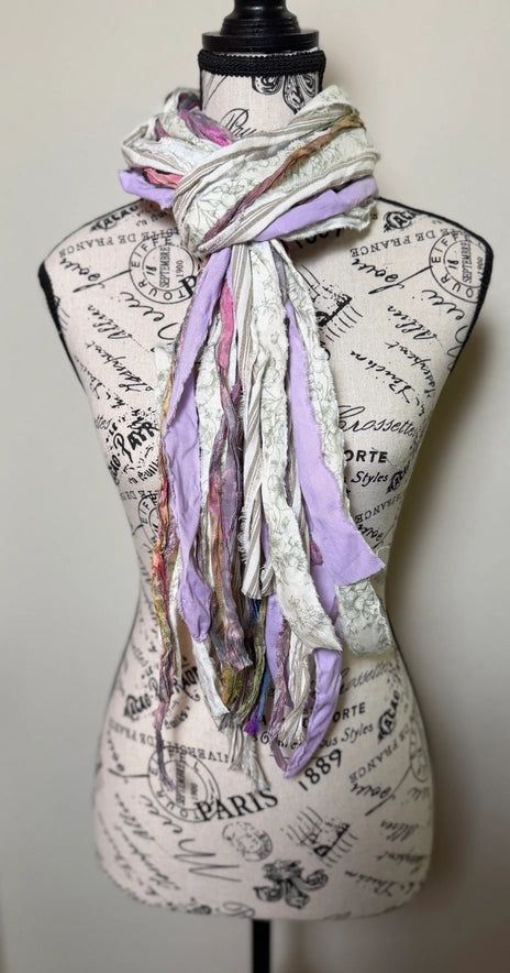 Scarf draped over a mannequin bust with script design