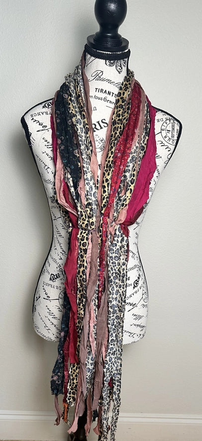 Multicolored patterned scarf on a mannequin with a white background