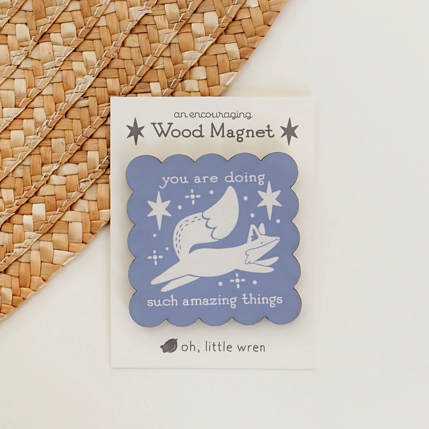 Wood magnet with motivational message on a woven surface