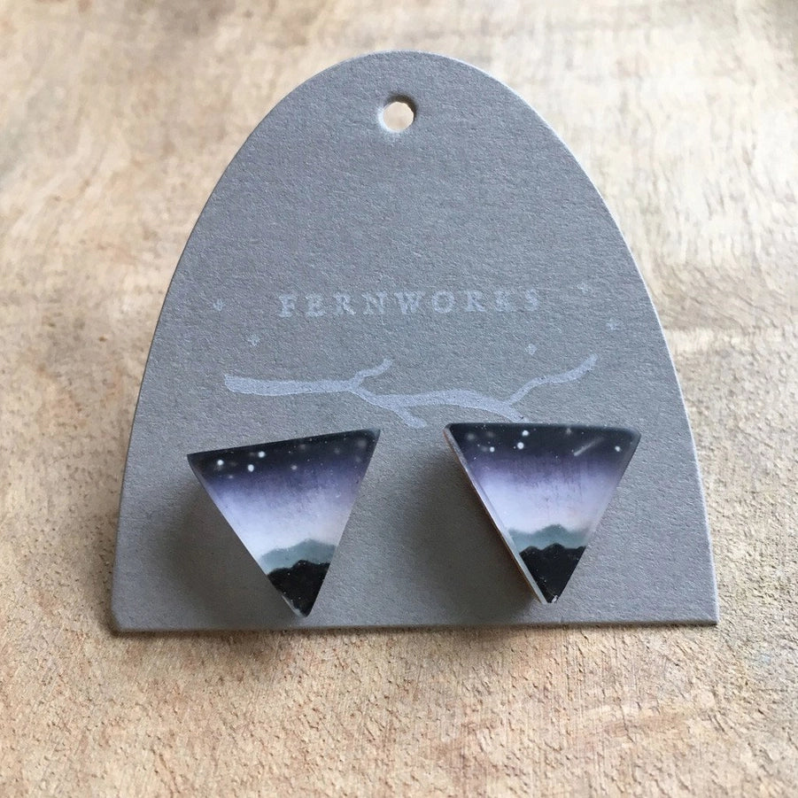 Triangular earrings on a Fernworks branded card against a beige background