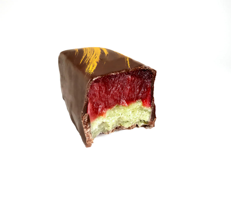 Chocolate-covered candy bar with a red and green interior on a white background
