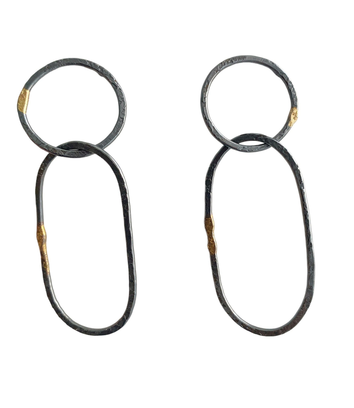 Open circle stud earrings with an intersecting oval dangling, dark oxidized sterling silver with 18k gold accents