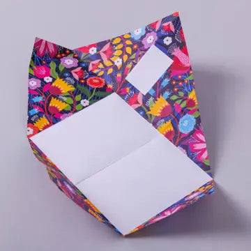 Colorful floral-patterned box with a white interior on a gray background