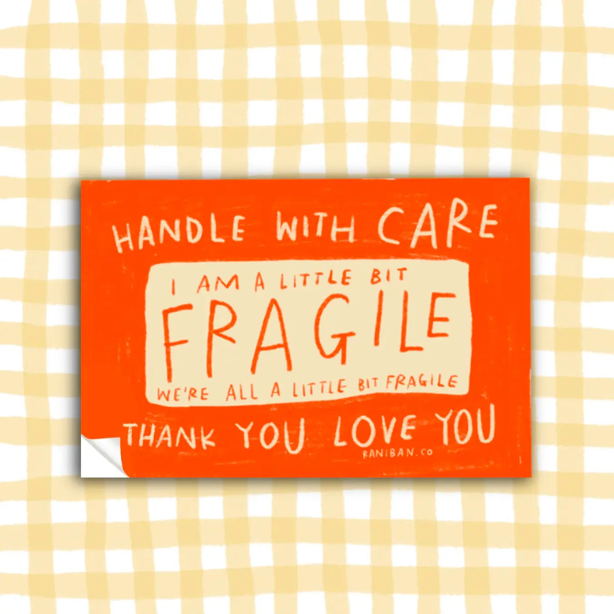 Orange sticker with text on a checkered background