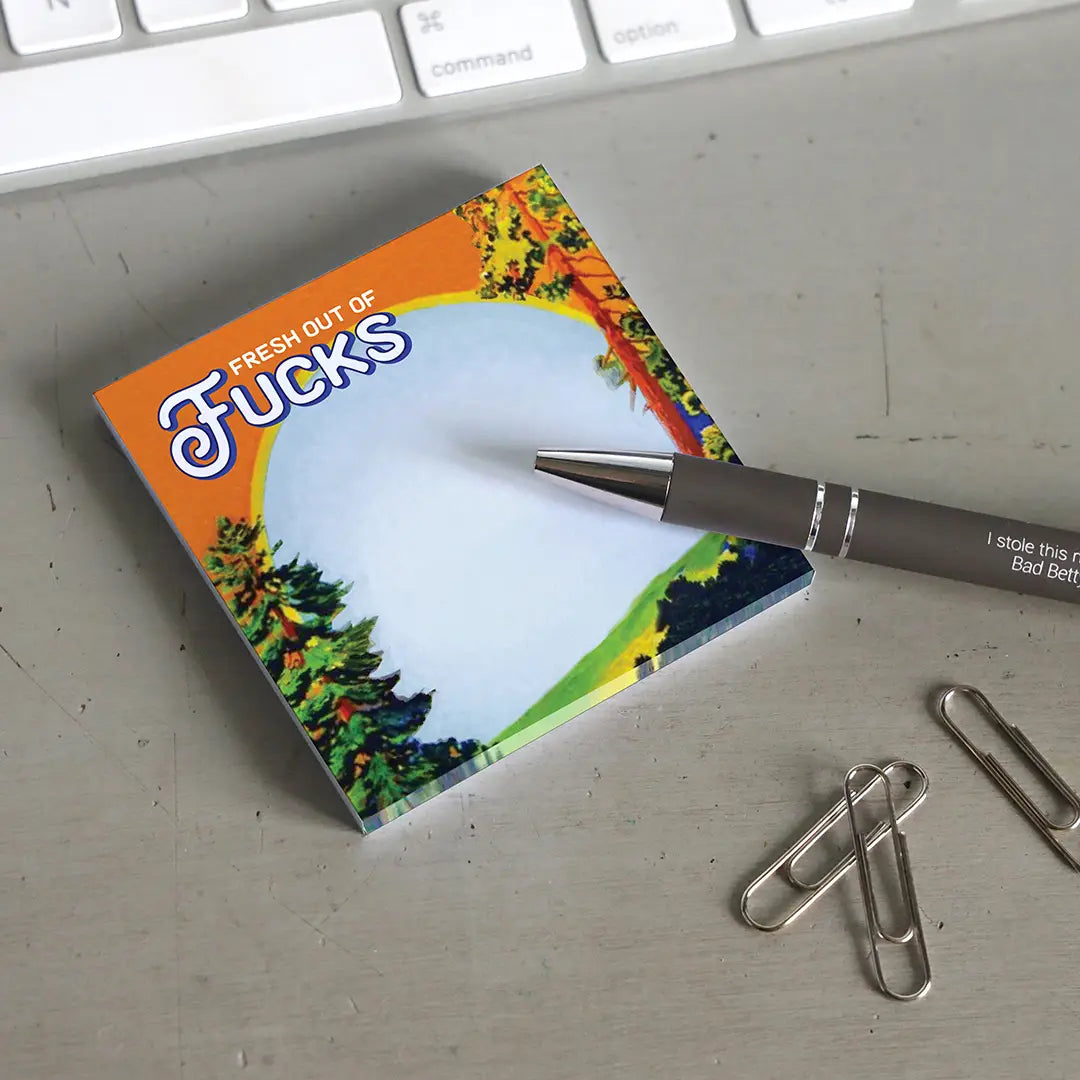 Colorful notepad with a pen and paper clips on a desk