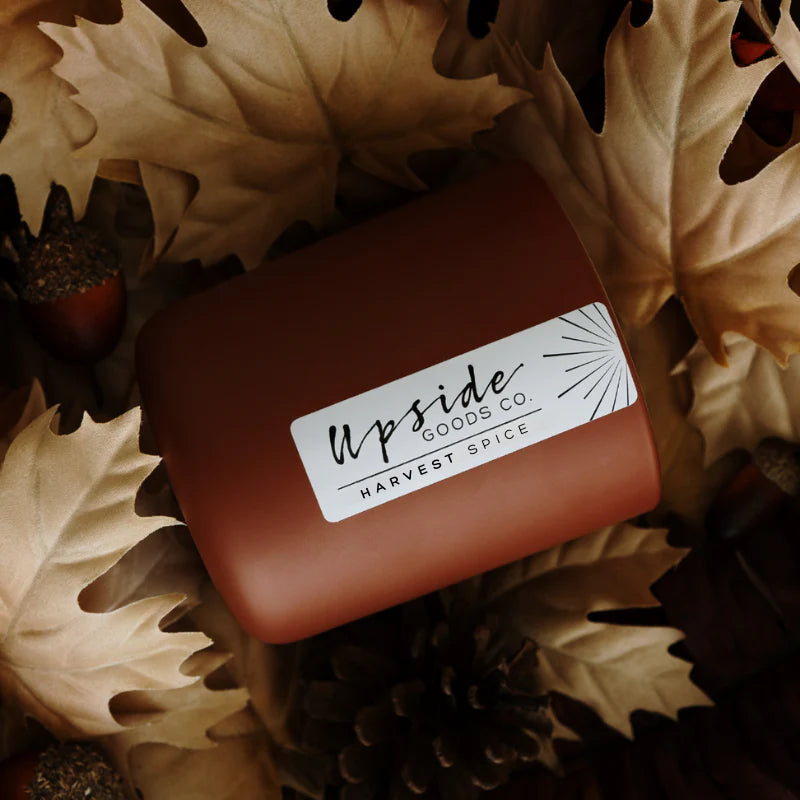 Rectangular container labeled 'Upside Goods Co' on a decorative background with leaves and pinecones.