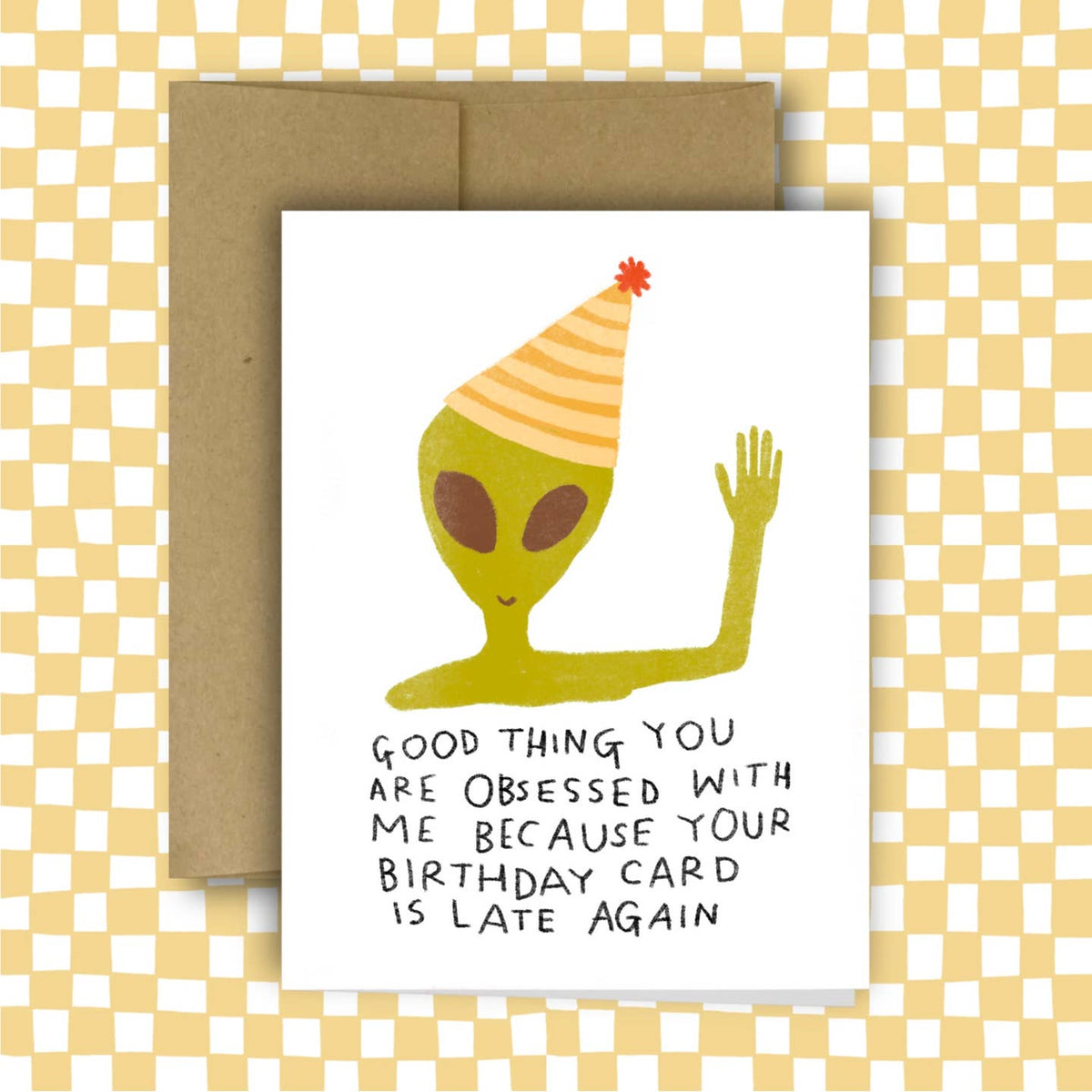 Birthday card with alien illustration and humorous text on a checkered background