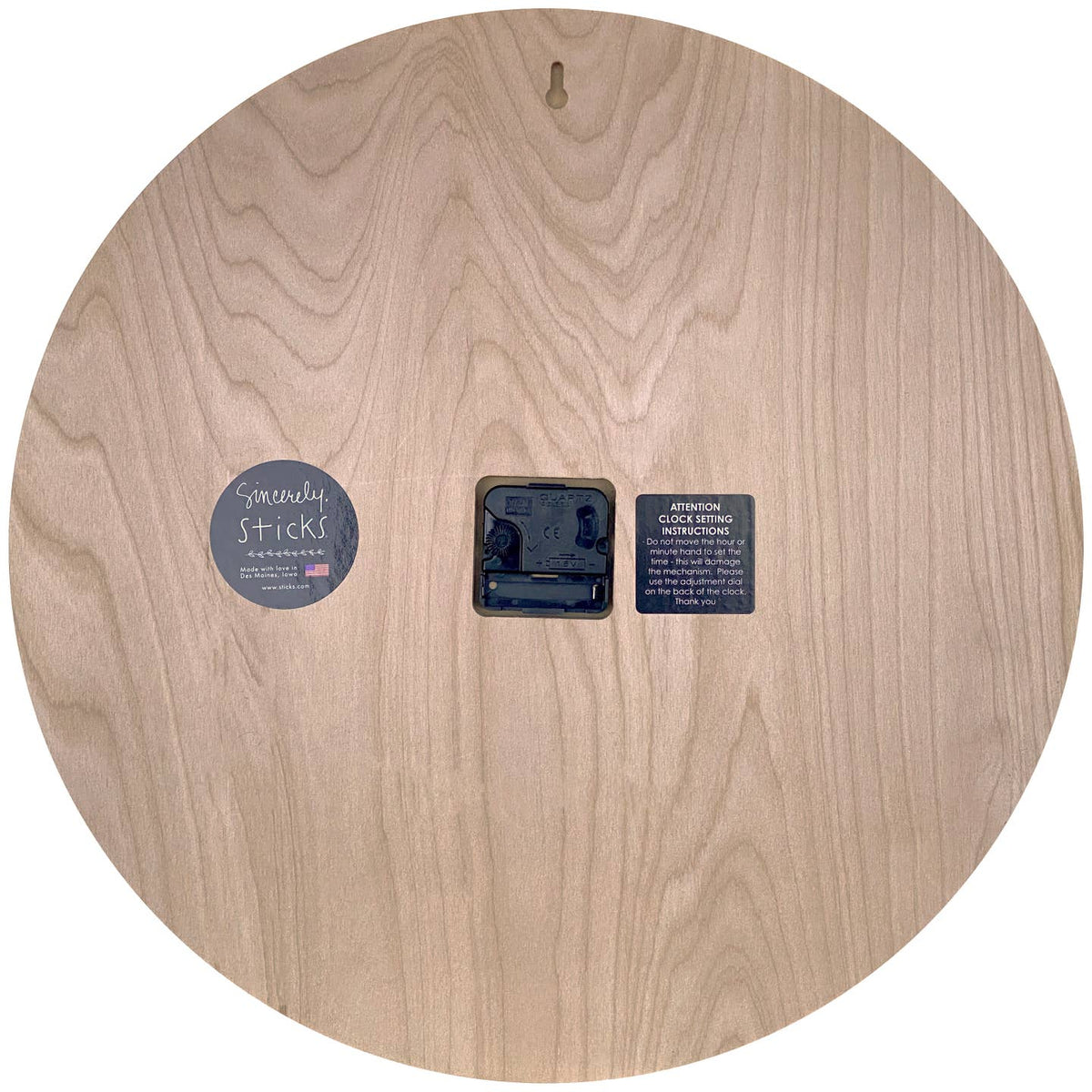 Wooden disc with a central hole and labels on a white background