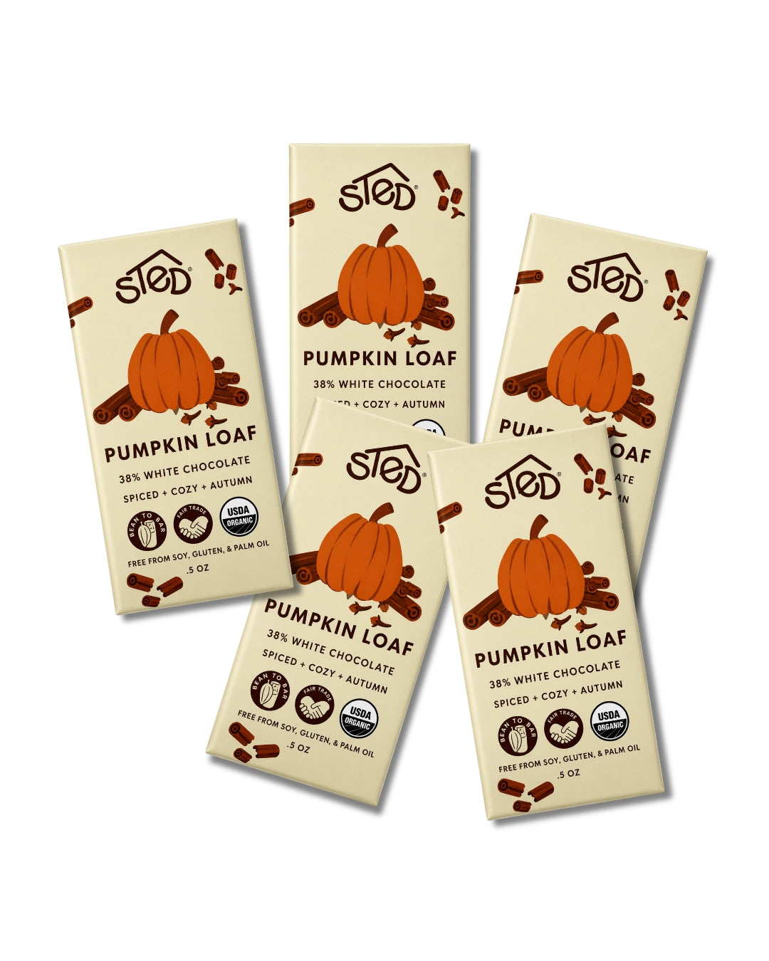 Five bars of Stod Pumpkin Loaf chocolate barranged on a plain white background. The packaging is cream-colored with illustrations of orange pumpkins, brown chocolate pieces, and black text.