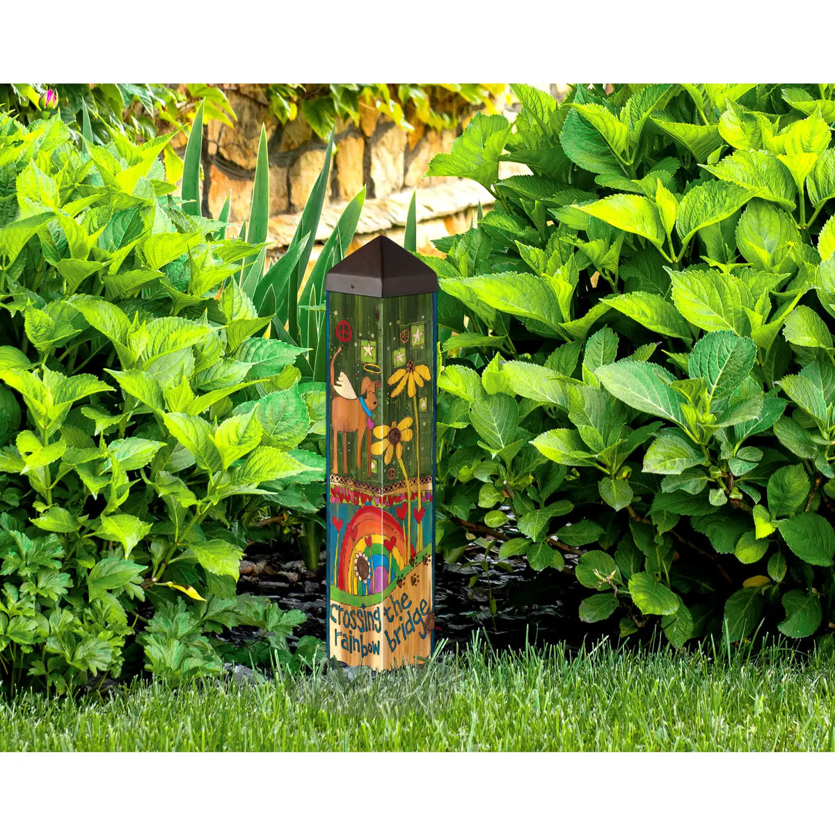 Decorative garden stake with colorful design in a garden setting