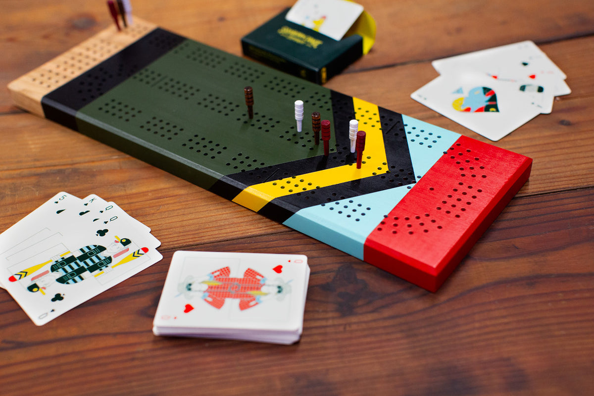 Board game with colorful components and playing cards on a wooden surface