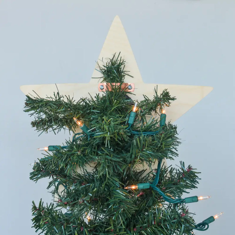 Star-shaped Christmas tree topper with lights on a light blue background