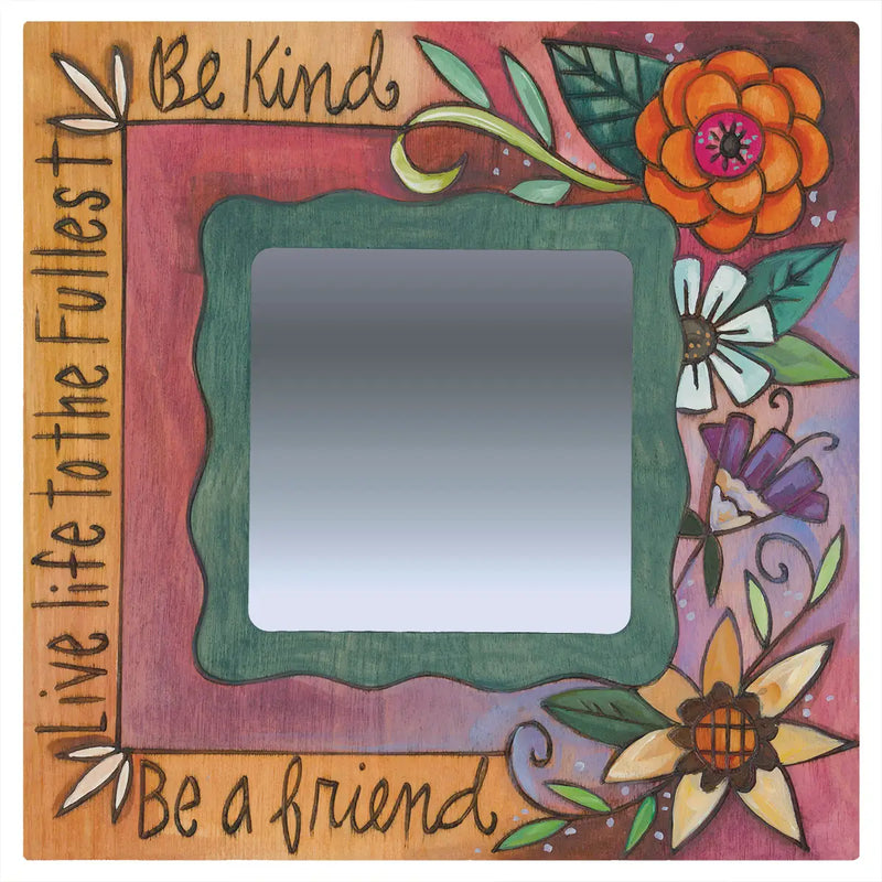 Decorative mirror with floral designs and motivational phrases on a wooden frame.