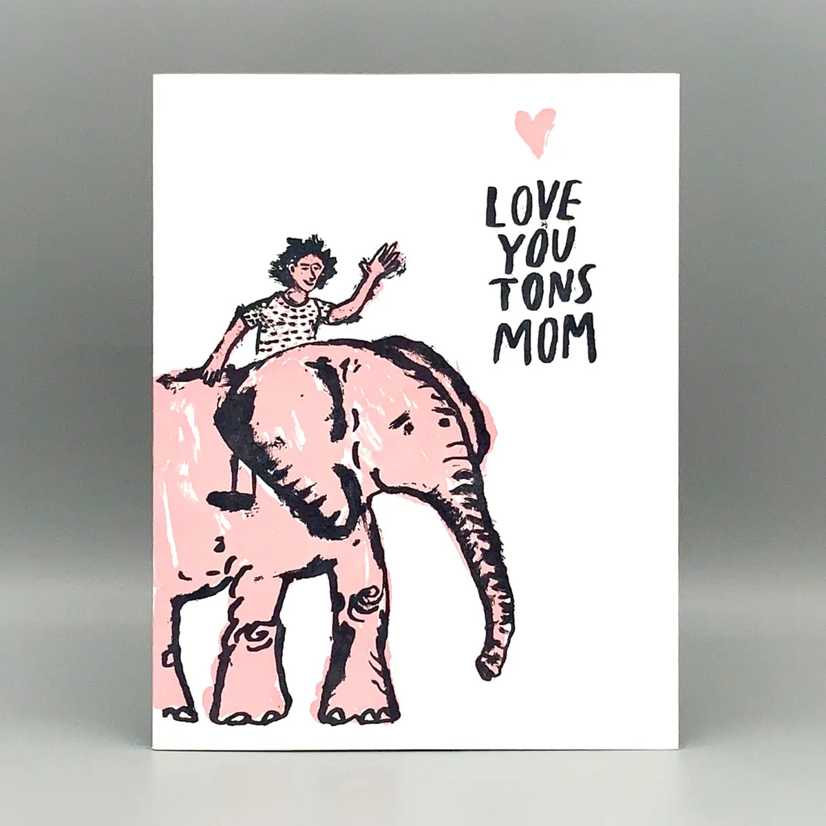 Card with illustration of a woman riding an elephant and 'Love You Tons Mom' text on a white background.