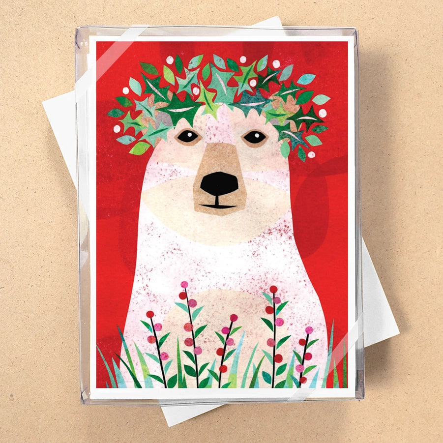Greeting card with a polar bear illustration wearing a floral wreath on a red background
