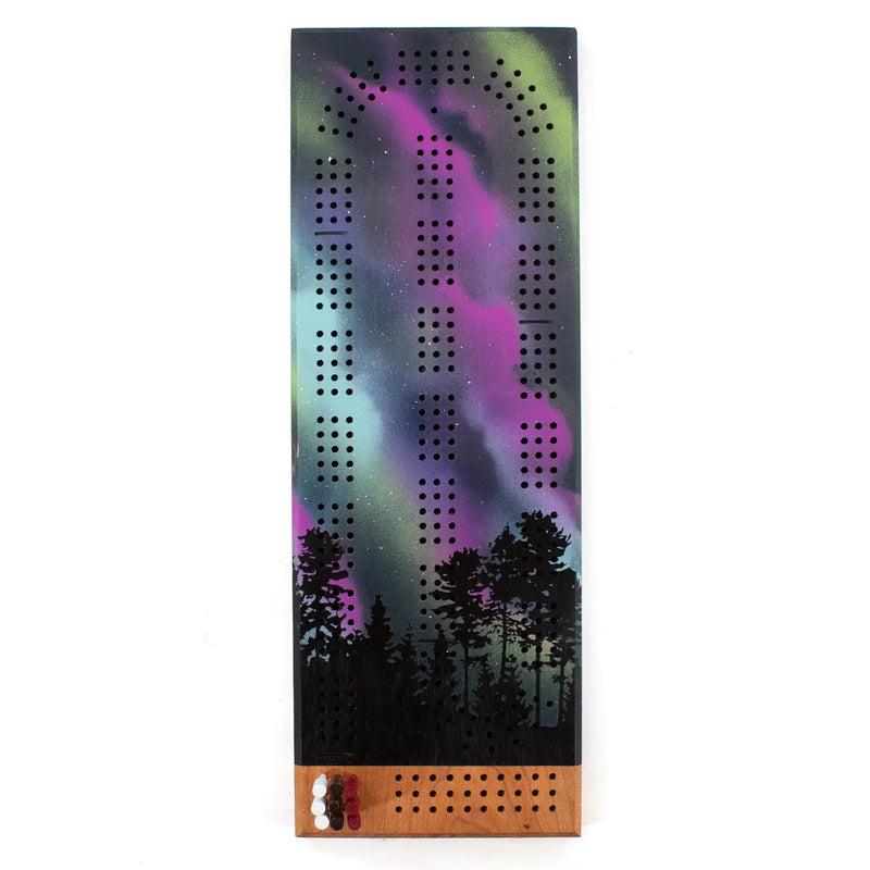 Cribbage board with Northern Lights design on a white background