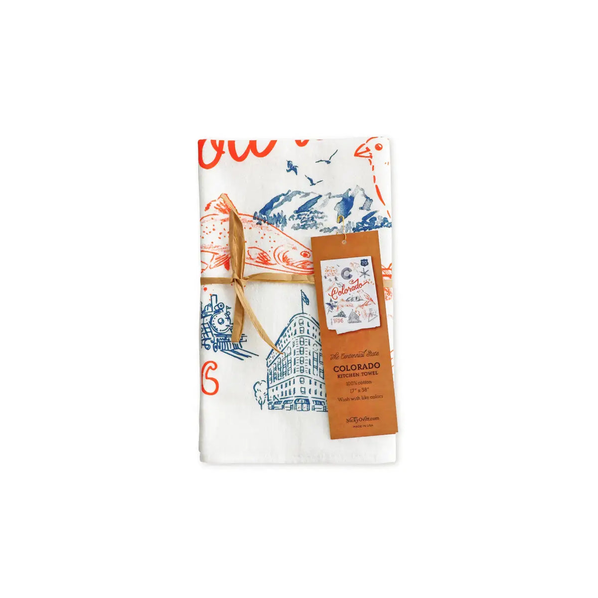 A folded white tea towel featuring a Colorado-themed illustration print with blue mountains and buildings, tied with a brown string and accompanied by a brown paper tag, shown on a plain white background.