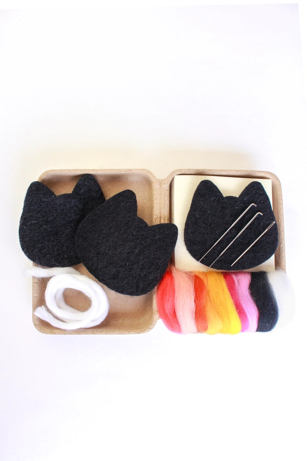 Black cat DIY felting kit in a box with colorful roving and a white yarn.