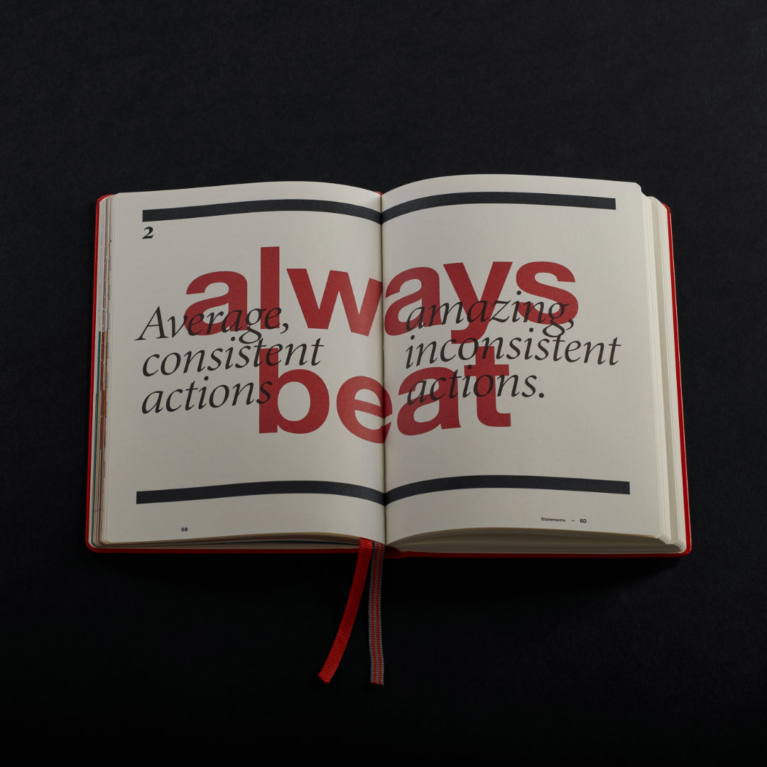 Open book with motivational text on a black background