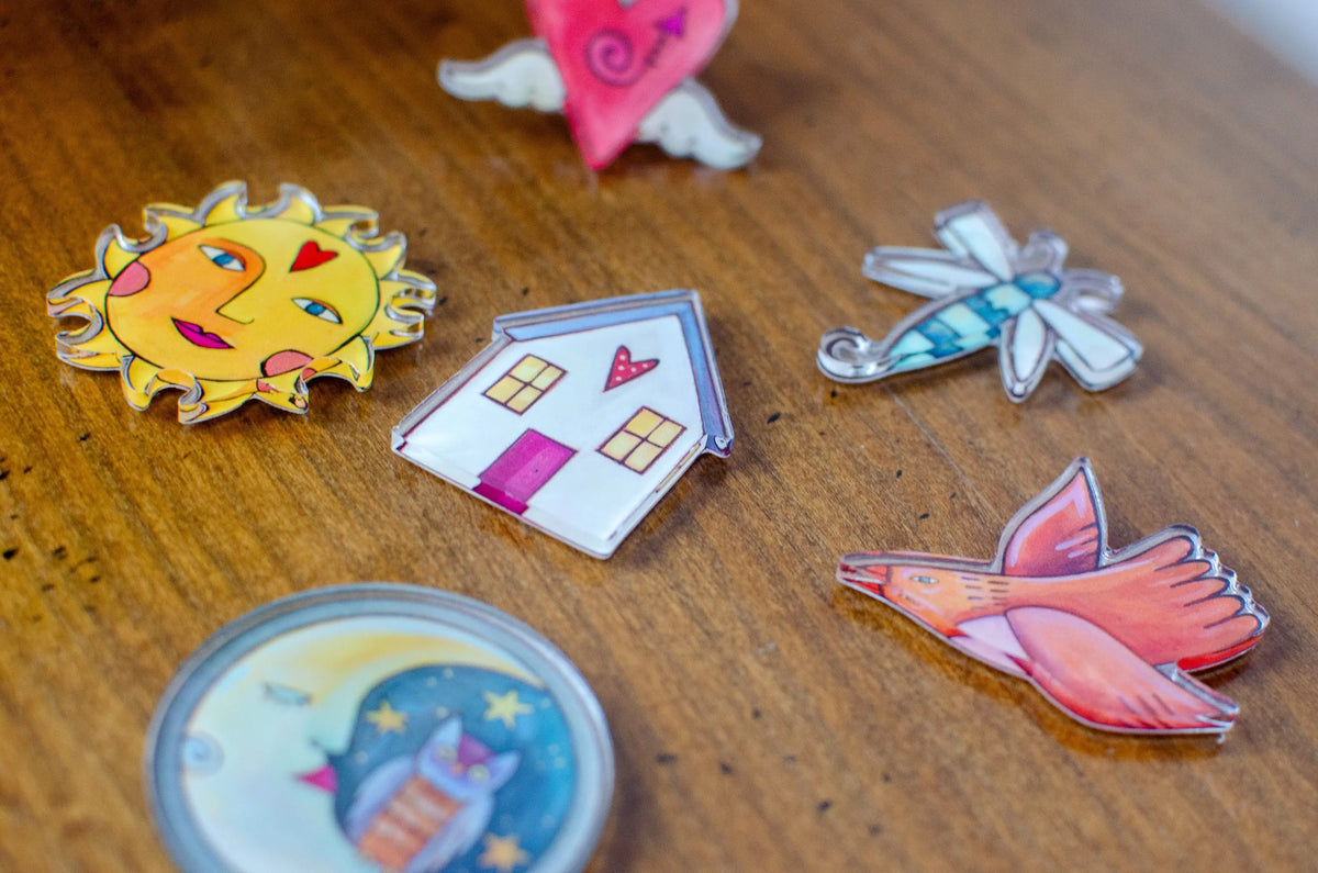 Colorful acrylic magnets on a wooden surface