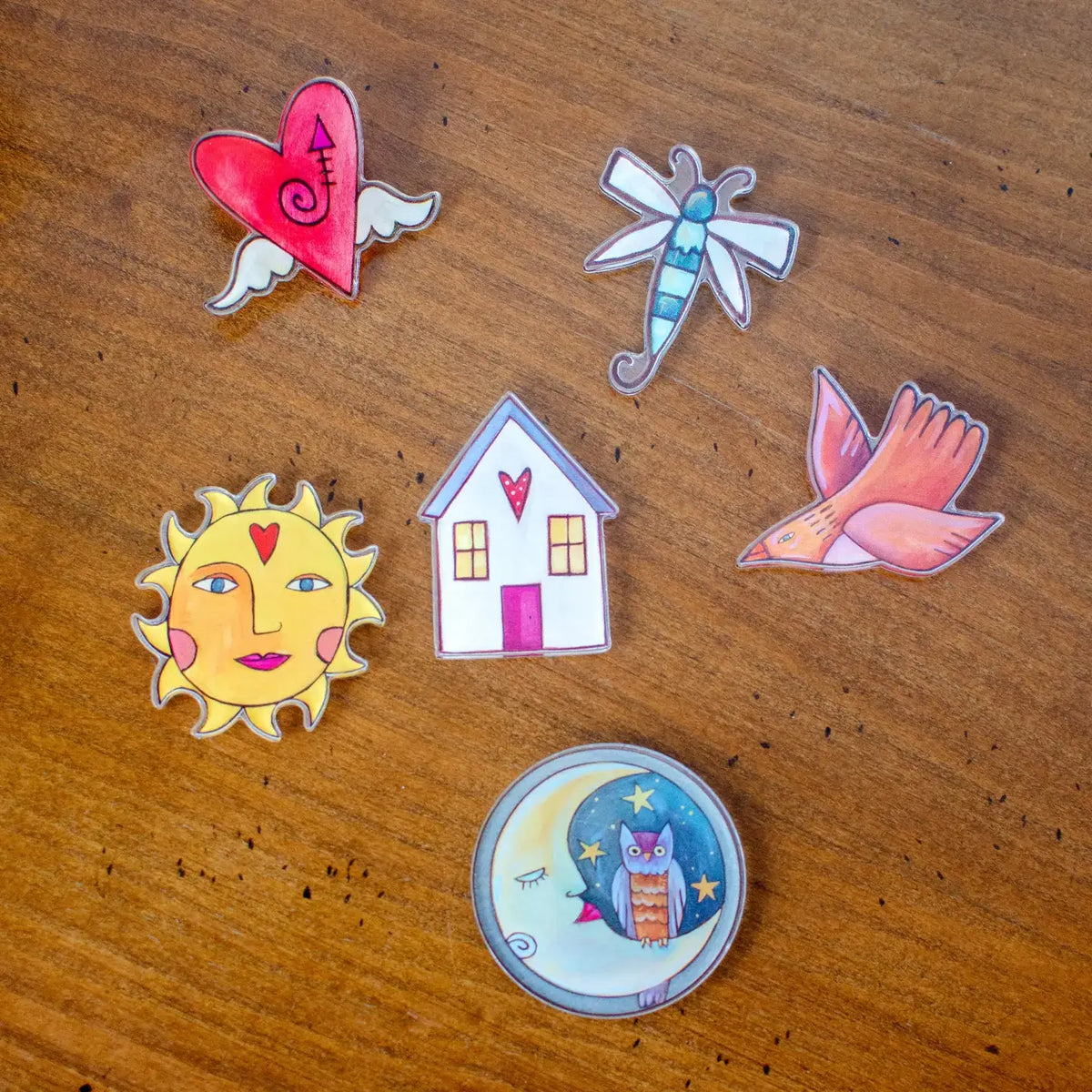 Collection of colorful magnets on a wooden surface