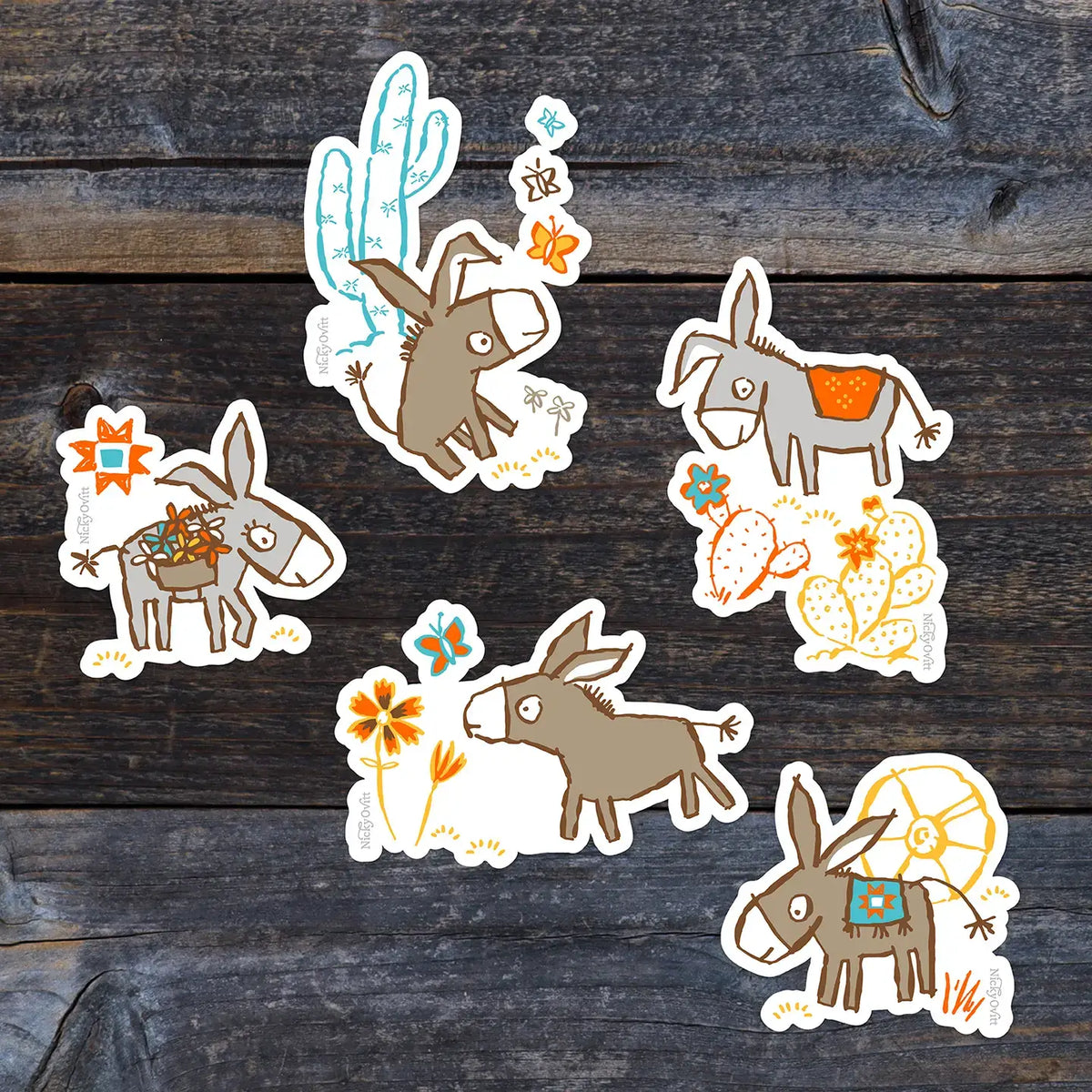 Set of six donkey stickers with cactus and flower designs on a wooden surface