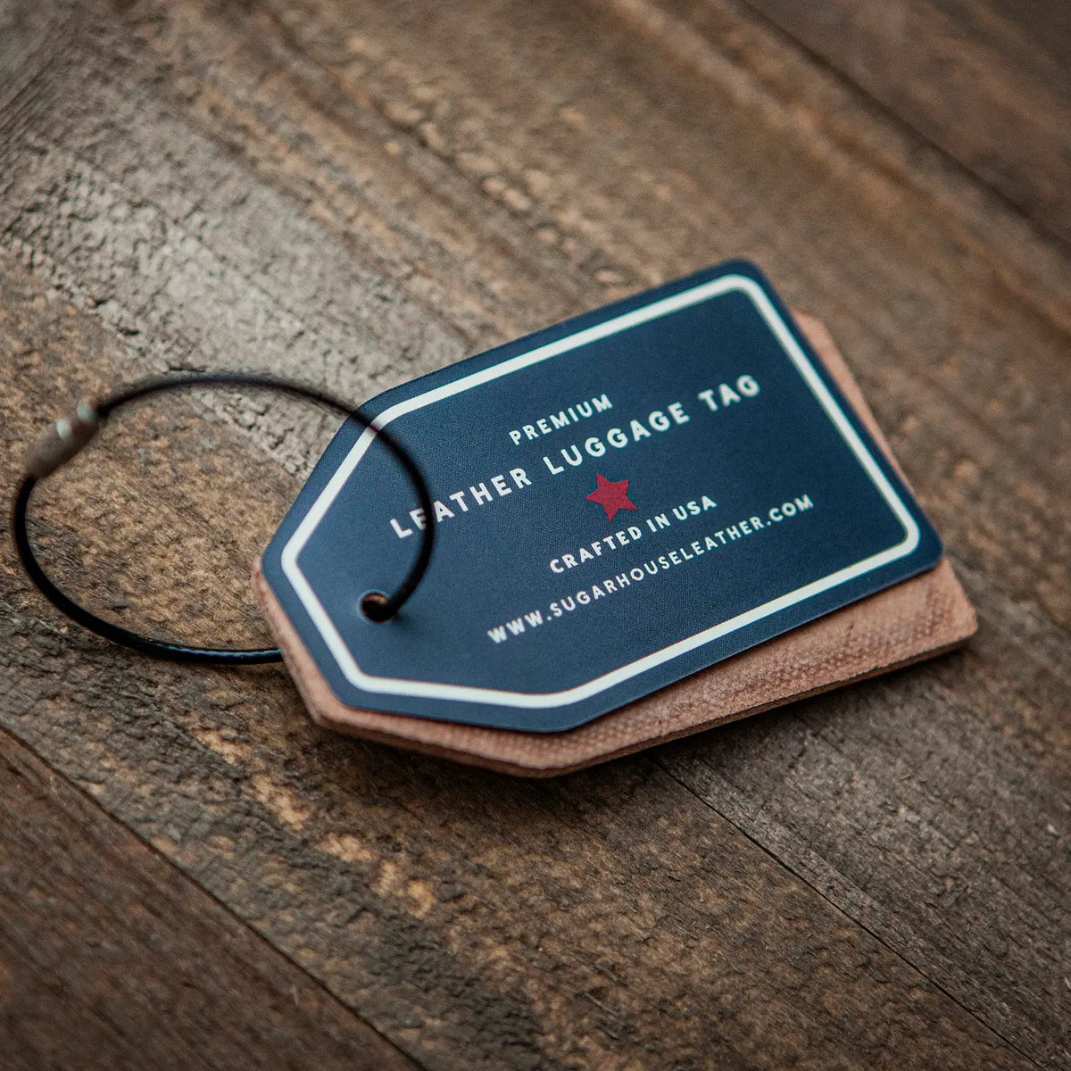 Leather luggage tag on a wooden surface