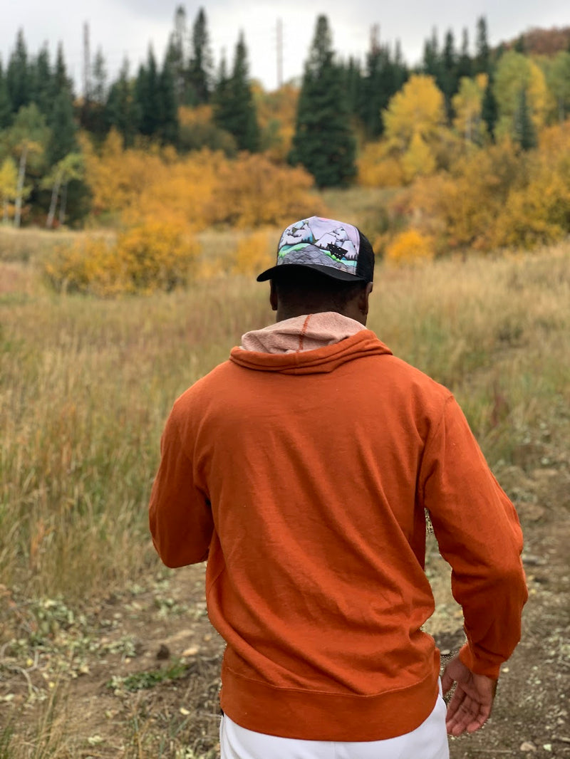 Minaret Snapback Hat on African American Male in field with aspen and pine trees