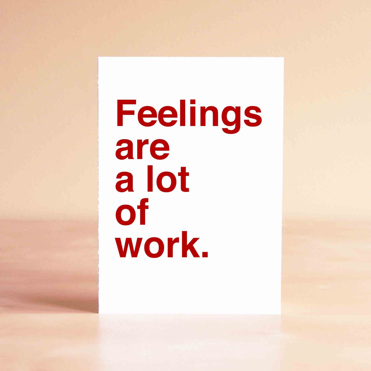 White card with red lettering reading "Feelings are a lot of work."