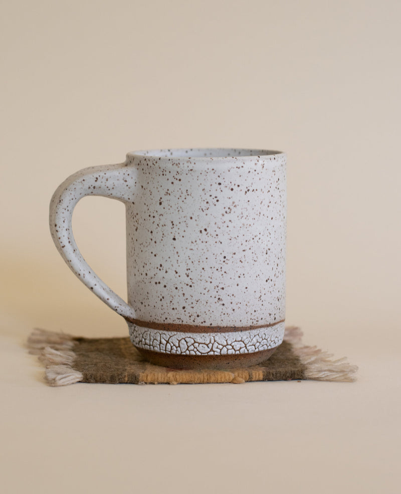 Satin White + Crawl Glaze on Speckled Buff Ceramic Mug displayed on a coaster rug
