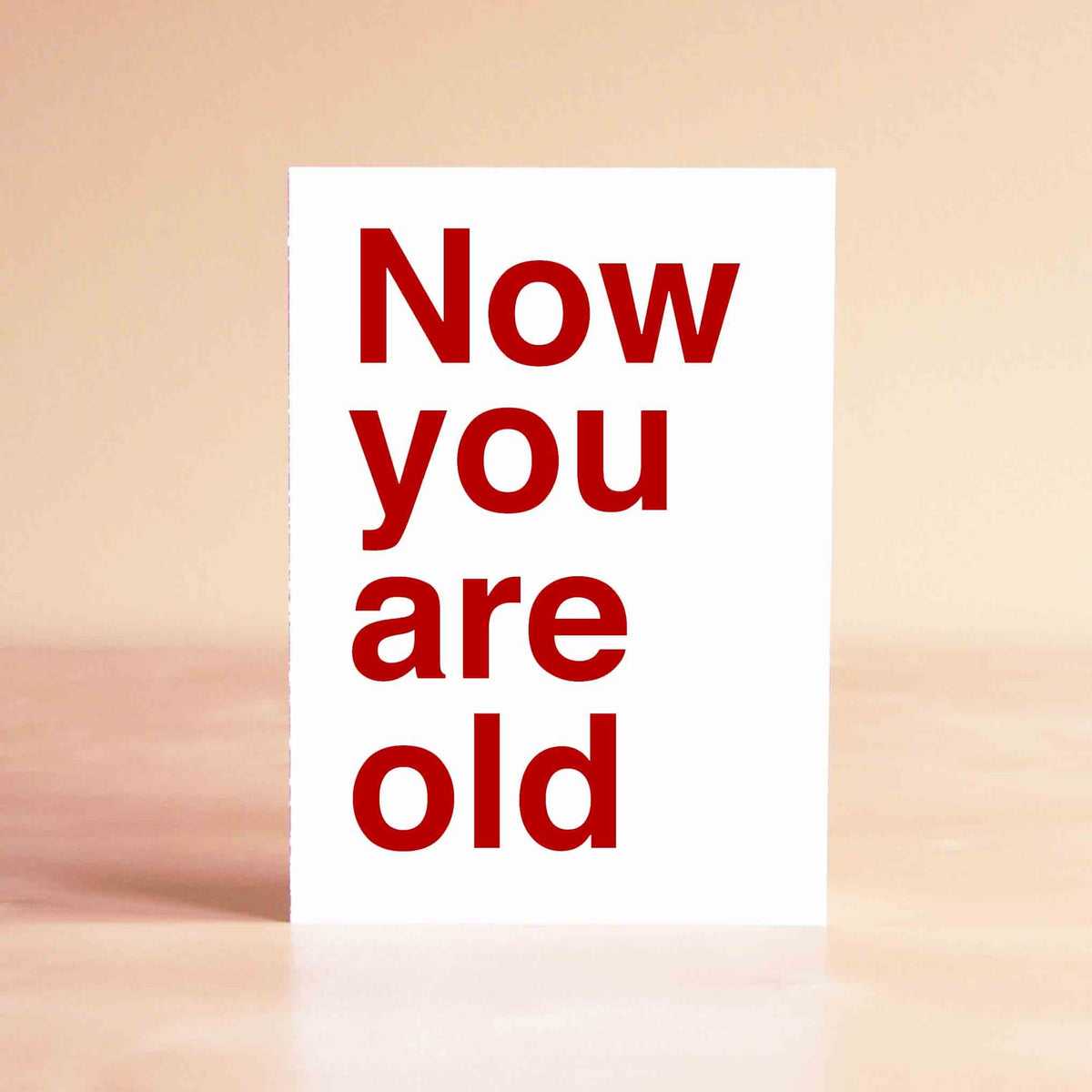 White card with very large red lettering reading "Now You Are Old."