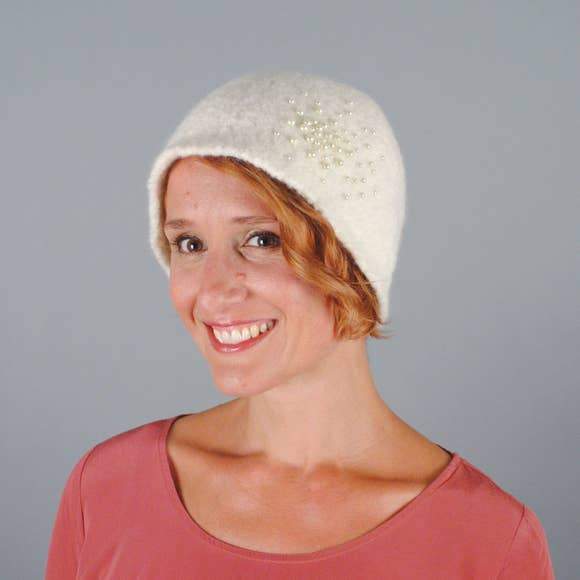 Model of a handmade pearled wool hat in white. Handmade by Julie Sinden Handmade.
